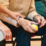 closeup of elderly hands holding a stress ball